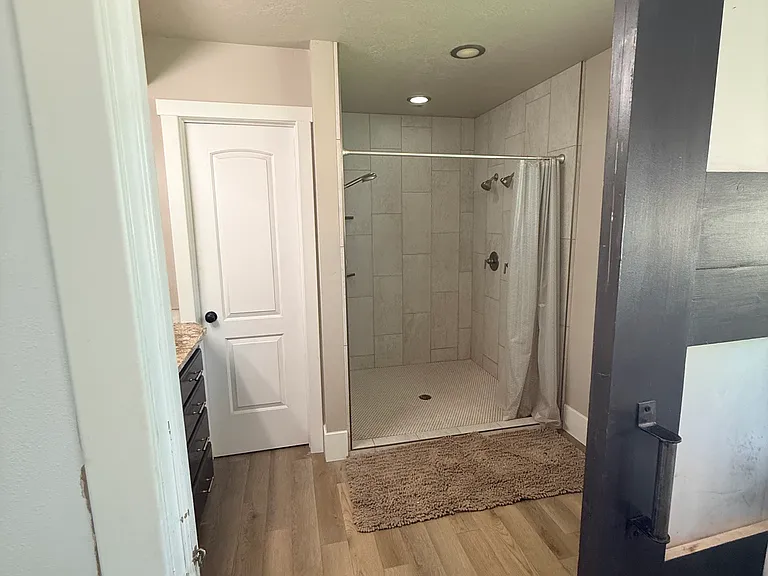 large walk in shower with 3 shower heads for a luxury feel