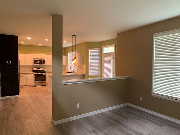 Lower level flows from living room to dining area to kitchen. Access to both the garage and fully-fenced backyard.