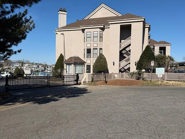 Lots of parking between behind security gate and cul-de-sac area. Building with GREAT view next to water.