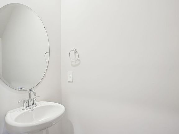 The half bathroom is conveniently located on the first floor for guests and visitors.