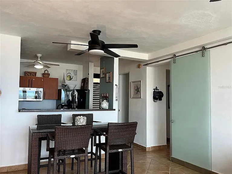 Open kitchen with dining table and chairs flowing into the living room