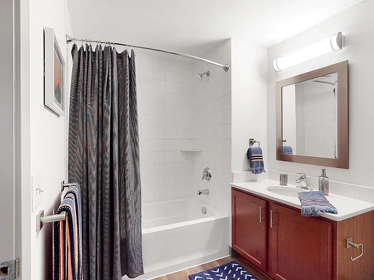 Our bathrooms feature a clean and modern design with a full-size tub and shower, perfect for relaxing and refreshing.