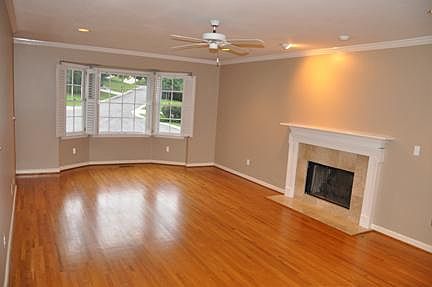 Large den with gas fireplace and bay window includes window 