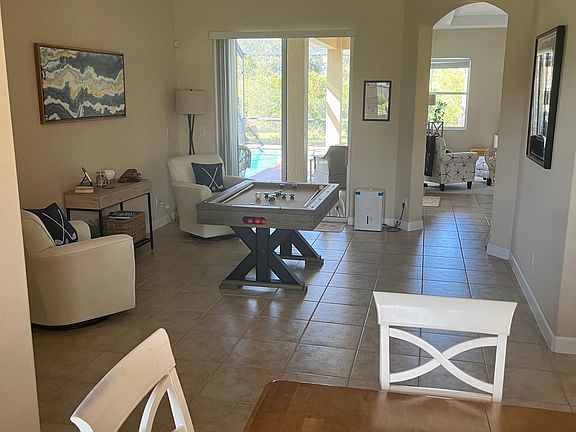 Living room equipped with games, puzzles, books and bumper pool.