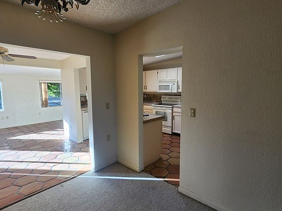 View from living room looking into dining area, kitchen on right, AZ room