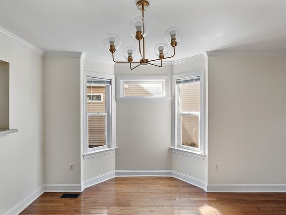 Bay windows in dining area with new dining chandelier