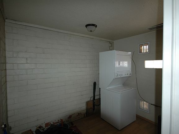 INSIDE LAUNDRY ROOM STACK WASHER AND DRYER INCLUDED LARGE ROOM TOO FOR STORAGE