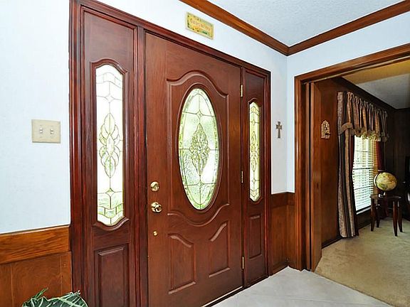 Double paneled door entry with large tiled floor foyer.