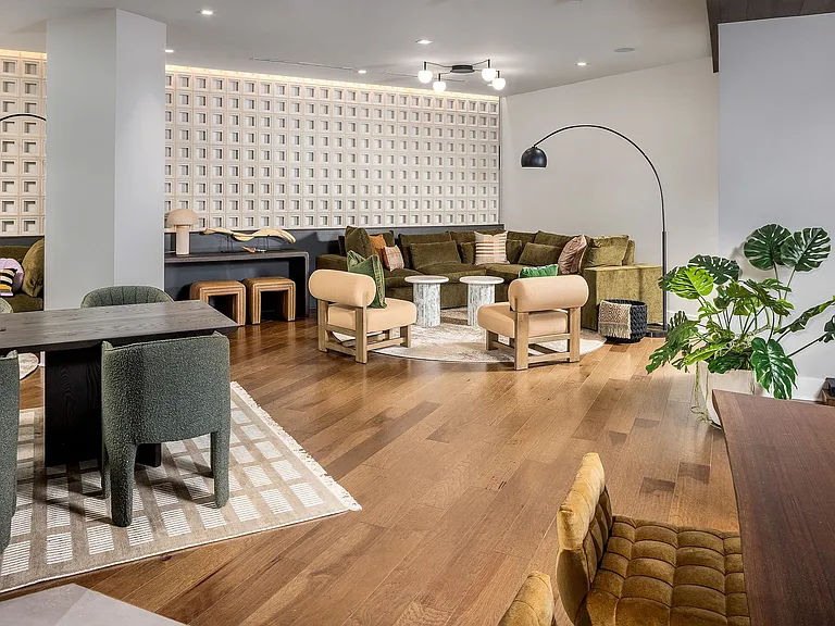 Resident lounge with plush velvet seating and marble tables
