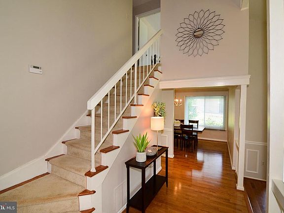 Gleaming engineered hardwood and elegant columns