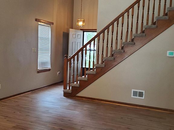 living room, front door, steps to go upstairs