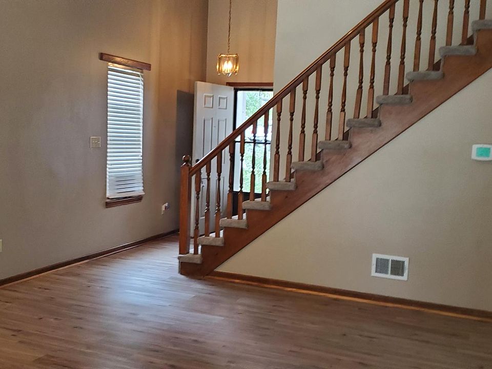 living room, front door, steps to go upstairs