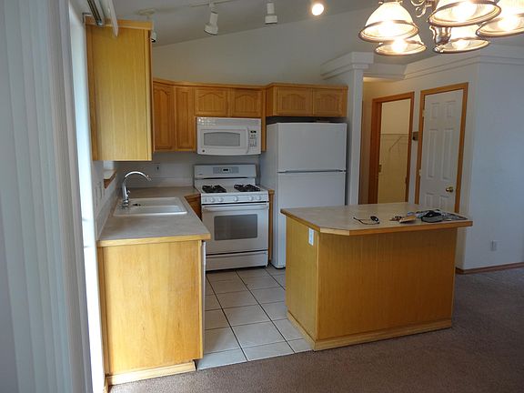 KITCHEN HAS BFST BAR, ISLAND AND COMES WITH THE DSHWASHER,STOVE,MICROWAVE AND REFRIGERATOR,PANTRY IN HALLWAY
