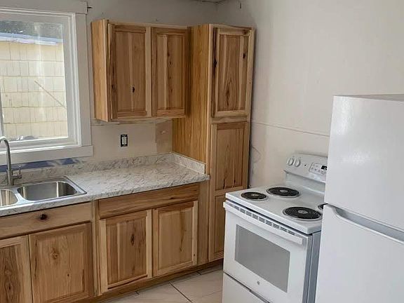 Right side of kitchen with newer cabinets, stove and refrigerator!
