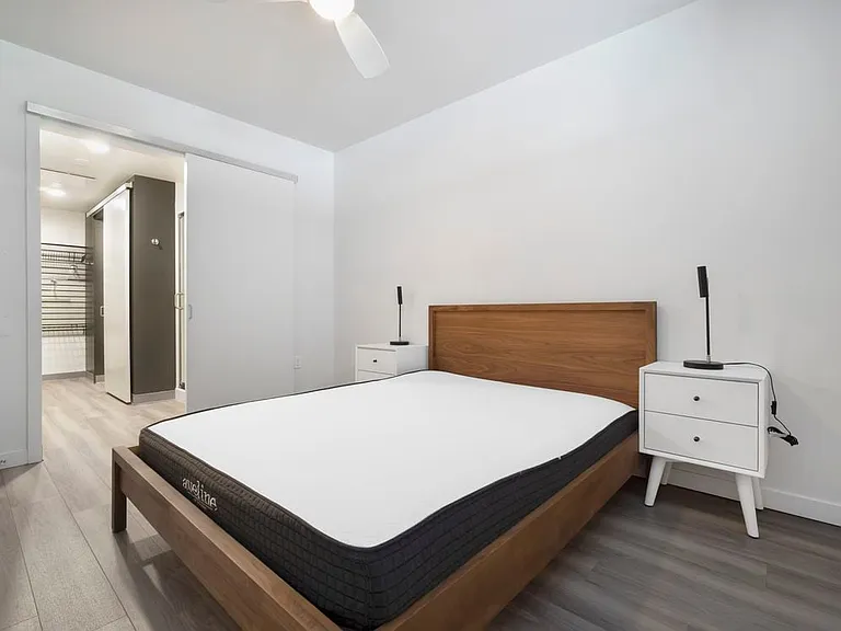 Furnished+ apartment homes feature queen bed with mattress, dresser, nightstands, and lamps (Representative Image exact items and style of furnishings may vary)