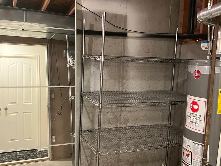 Large mirror and storage shelves in laundry room