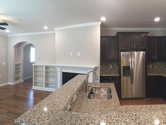 Granite countertop, mosaic backsplash, & counter depth refri