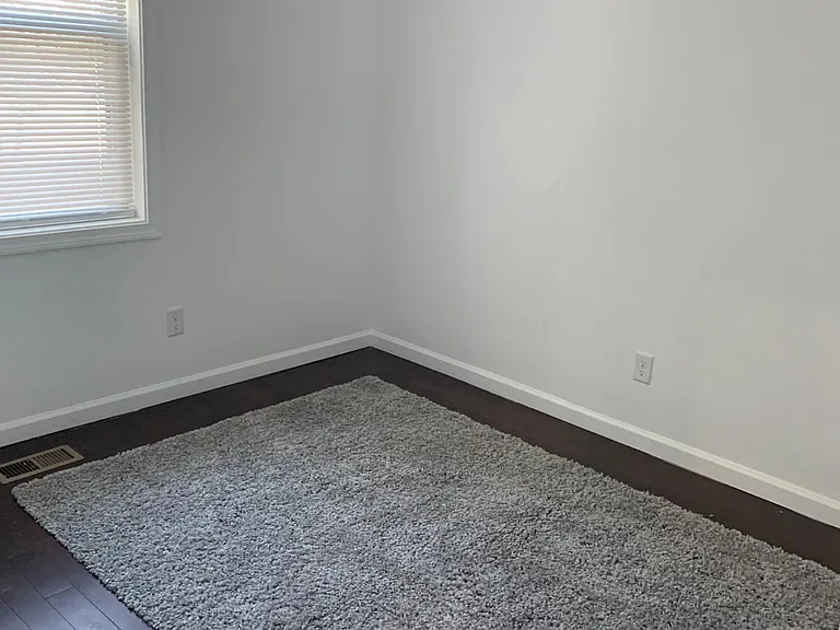 One bedroom with hardwood floors.