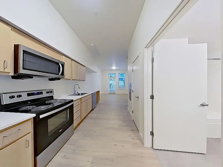 Kitchen with door to bathroom on right