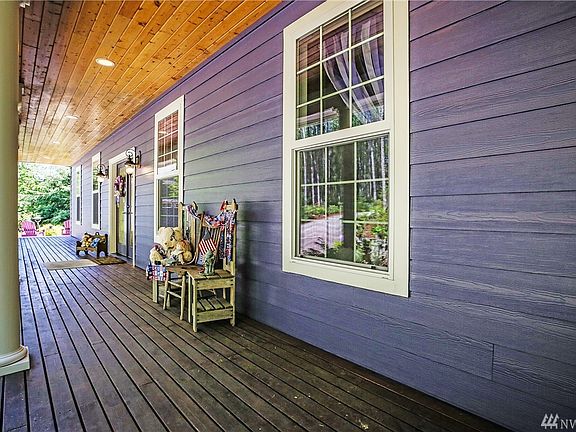Relax on this full length front porch in the summer or winter! Beverage anyone?