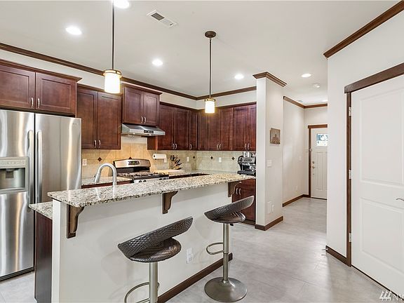 NO carpet anywhere in this house! Tile floors on main, with slab granite counters and stainless appliances