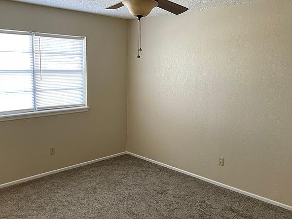 Main bedroom is bright with fresh carpet.