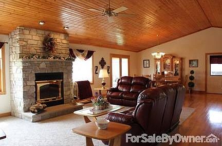 GREAT ROOM WITH VAULTED WOOD CEILING & STONE FIREPLACE
