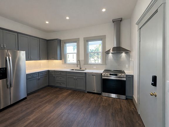Modern, eat in kitchen, door on the left goes tot he front porch. There is a half bath opposite the refrigerator (not pictured)
