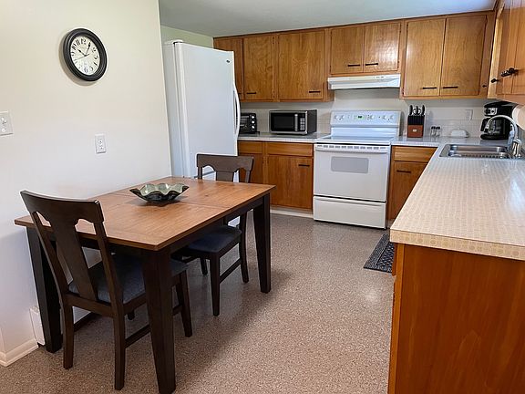 Kitchen complete with everything you need including microwave, toaster oven, coffee maker, pots and pans, dinnerware set, glasses and coffee cups.