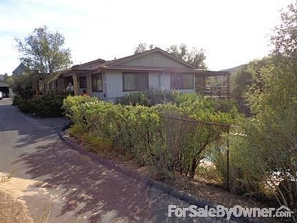 House view from North
						:
						View of house driving up the driveway. pool is to the right