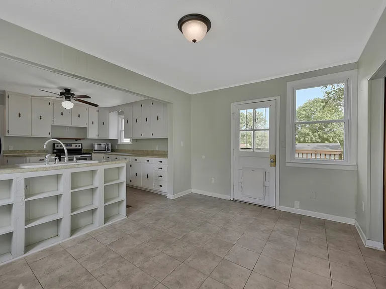 Photo 12. Open Kitchen and Dining area and door leading to back deck