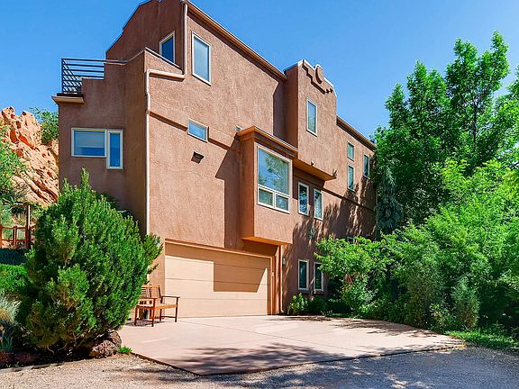 The private side entryway highlighting the custom nature of the home and the balcony off the master bedroom looking out onto the Pikes Peak mountain range.