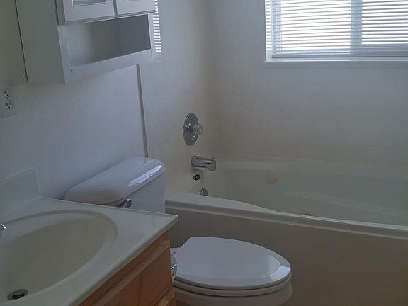Second bathroom has jetted tub with shower