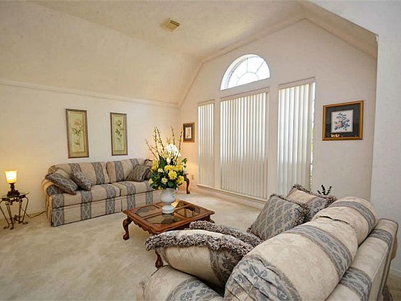 High ceilings, naturally lit from the beautiful front window with vertical blinds, this is the perfect room for visiting with friends and family.