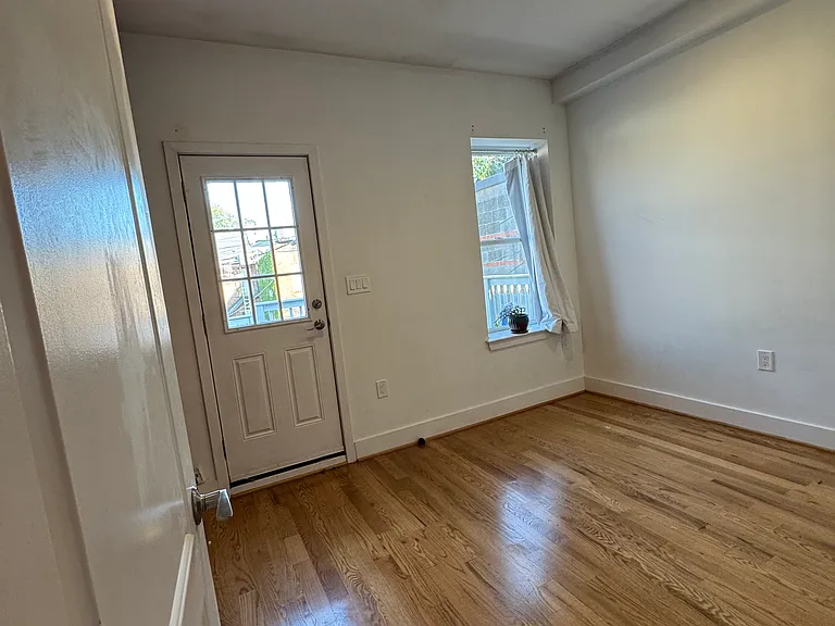 Third bedroom on second floor, featuring private entrance/exit to the patio