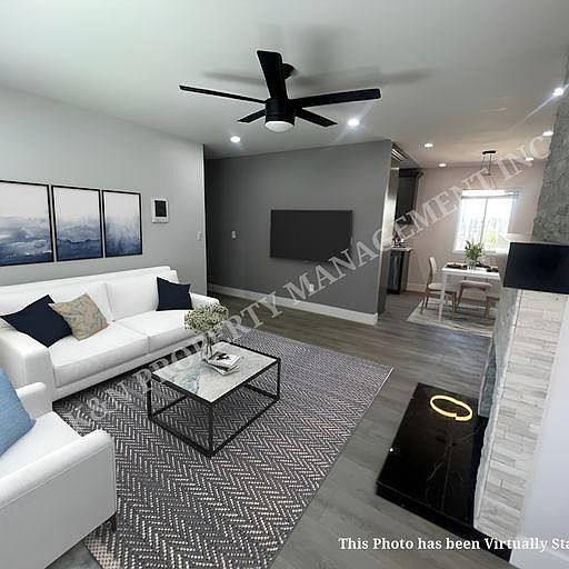 large open living room with lots of can lights and natural light