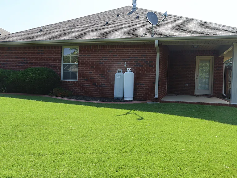 Back of house with concrete patio