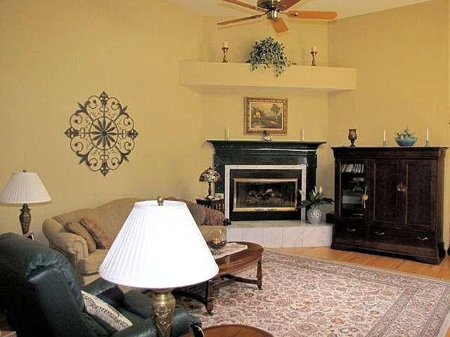 Living Room/Great Room with hardwood floor, cathedral ceiling, skylight & gas fireplace!