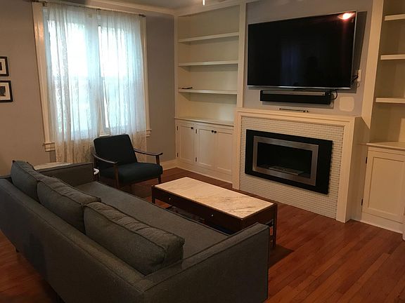 Living room with built in shelves nd custom ethanol fireplace