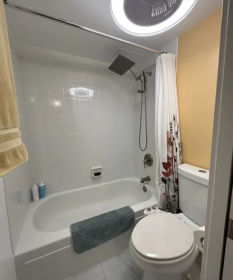 smart light with fan in remodeled bathroom, sliding pocket door for privacy