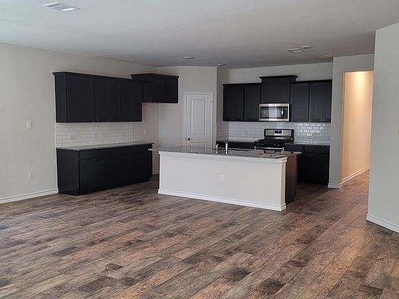Open plan Kitchen/Dining/Living. Refrigerator not shown but WILL BE PROVIDED by landlord.