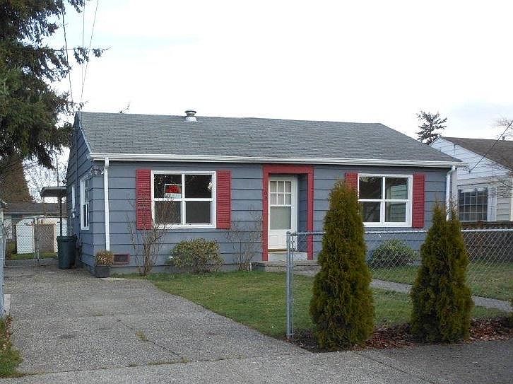 Front of the home. This is an older photo before painting. Now has brand new roof. Driveway on the left is deep, can fit two vehicles.