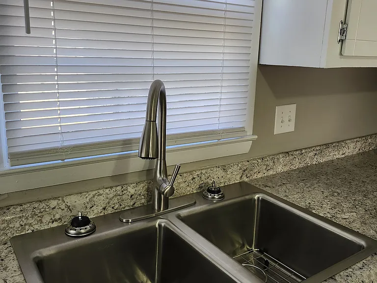 New double sink (deep), modern faucet and new venetian blinds.