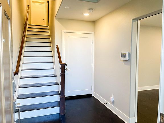 entry foyer with door to garage and opening to office