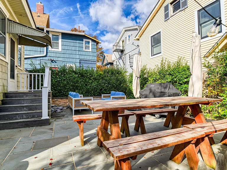 Roomy patio has large picnic table, comfortable seating, 2 large umbrellas, gas grill