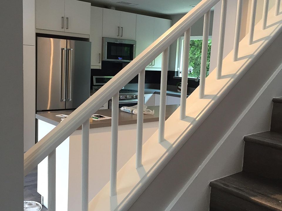 Half bathroom downstairs with a large living room, breakfast area and sliding glass doors leading to private covered patio.