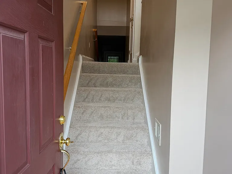 At the top of these stairs you can turn right to the living room or proceed straight to the family / recreation room.