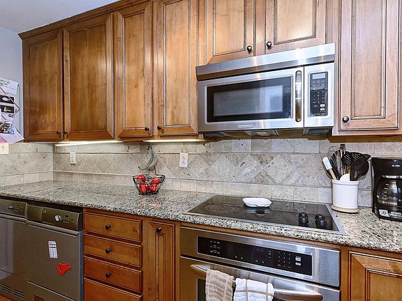 Updated cabinets and stainless steel appliances with built in dryer and washer for additional counter space.