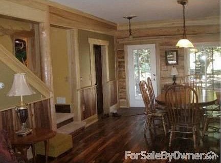 Living /dining areas with nat. log walls
						:
						Walnut floors, cherry posts and counter top add to the warmth of this cozy area.