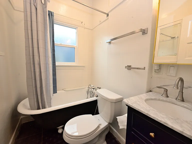upgraded bathroom with tiled floor, repainted claw foot tub